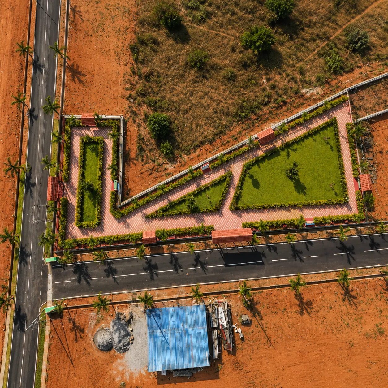 Aerial view of a developed plotted layout with internal roads and landscaped infrastructure